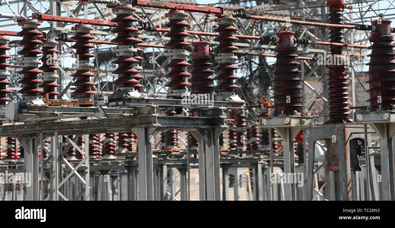 big industrial breakers of a power plant with high voltage power lines ...