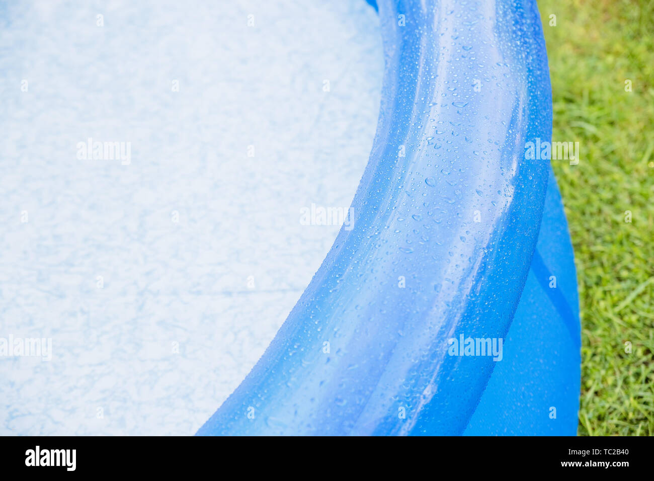 swimming in inflatable pool on lawn.inflatable blue water pool on grass