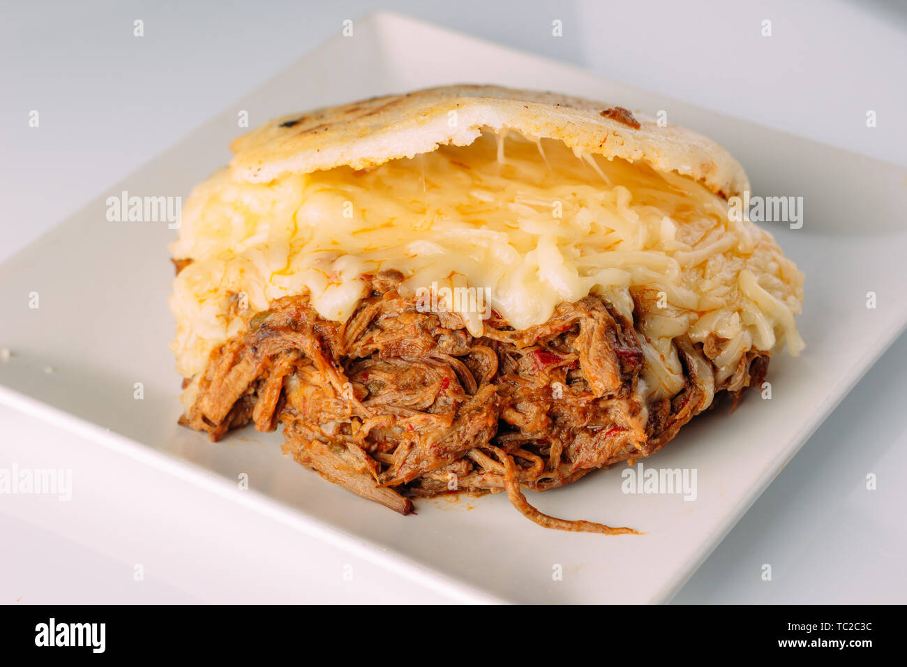 https://c8.alamy.com/comp/TC2C3C/arepas-south-american-food-made-from-piled-corn-TC2C3C.jpg