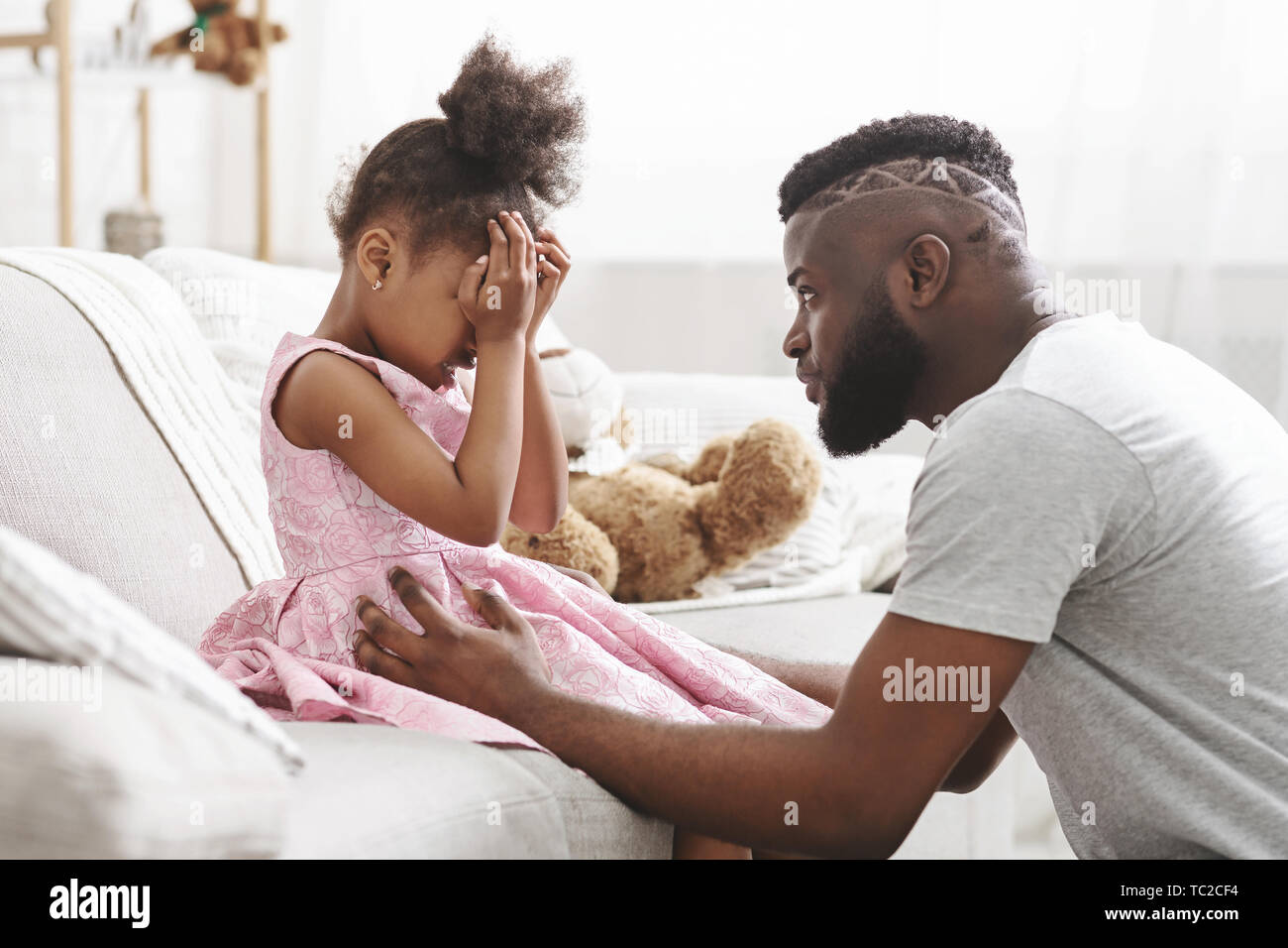 Loving african american dad comforting crying daughter Stock Photo