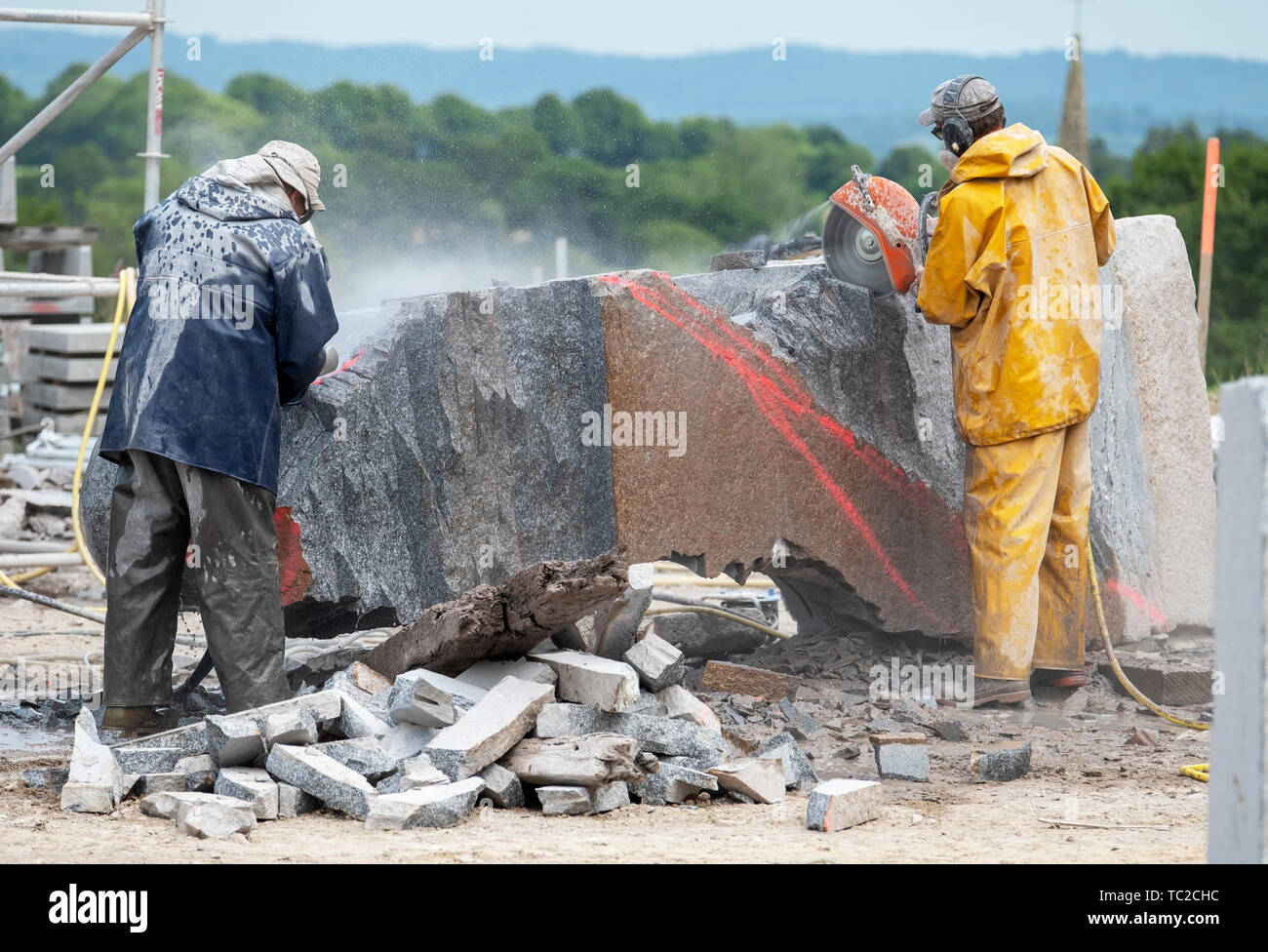 Sculptors cutting granite sculpture in the Valley of the Saints, Quenequillec, Brittany, France. Stock Photo