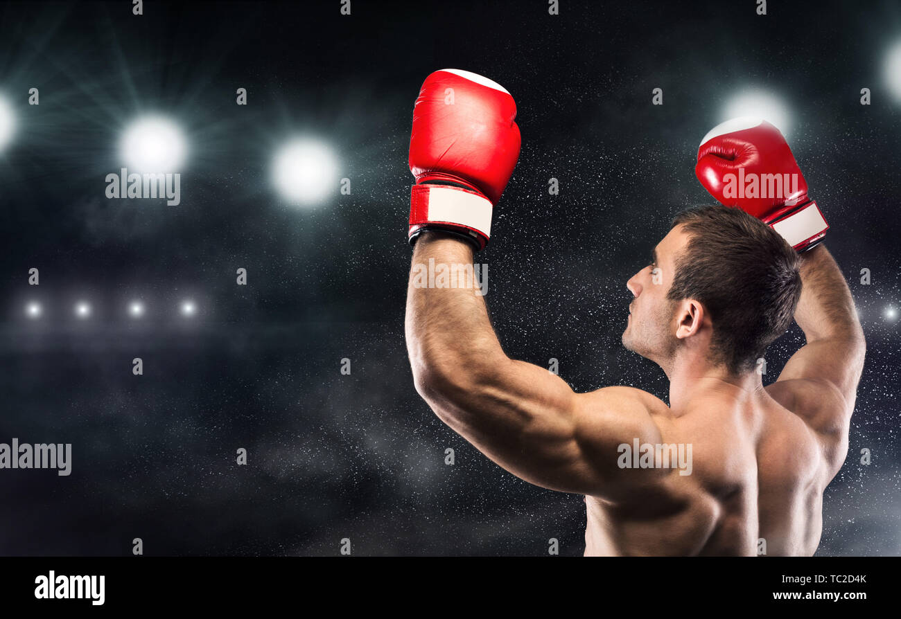 Young man boxer enjoying his win with hands up Stock Photo