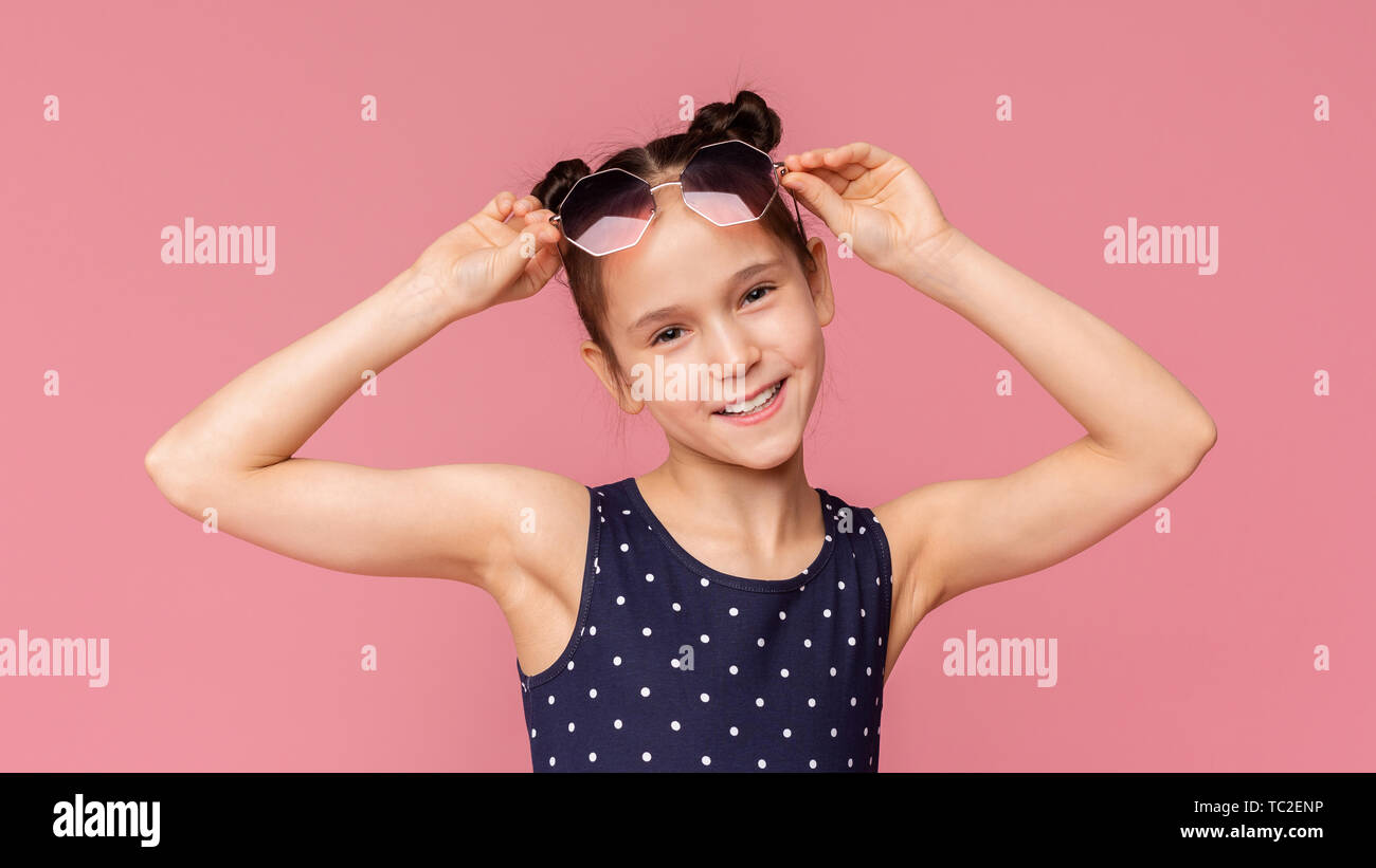 Adorable little girl wearing stylish sunglasses on pink Stock Photo Alamy