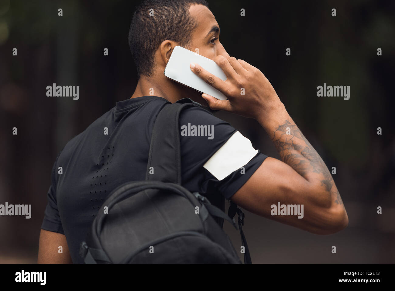 Sporty Man With Backpack Talking On Phone Stock Photo