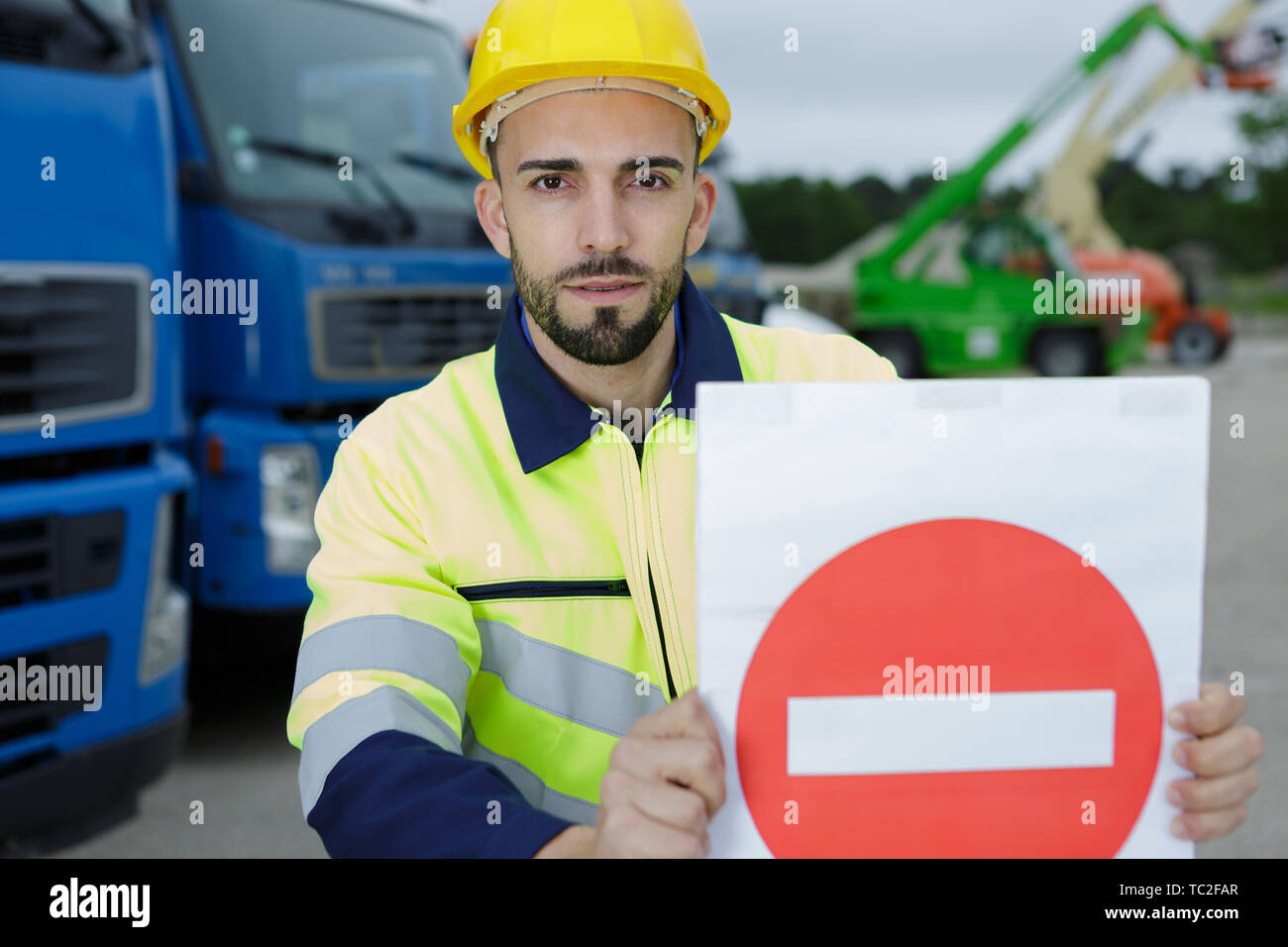 construction worker holding a sign Stock Photo - Alamy