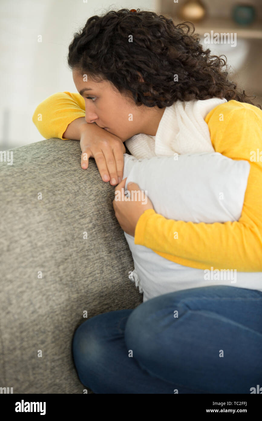 picture of a sad woman sitting on the sofa Stock Photo - Alamy