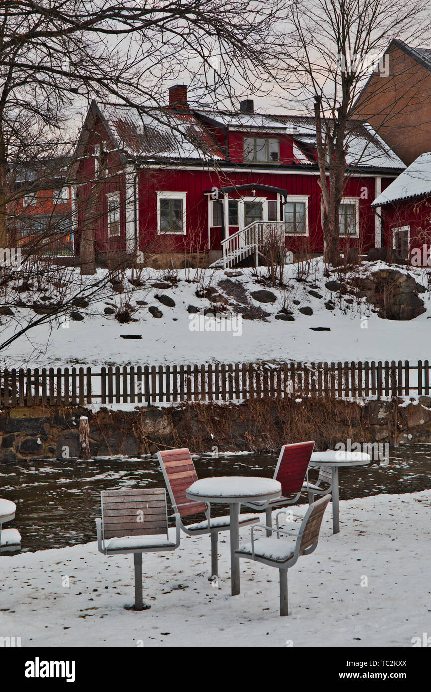 Winter scene with outdoor tables and chairs, Norrtalje river (Norrtaljean) Norrtalje, Stockholm County, Sweden, Scandinavia Stock Photo