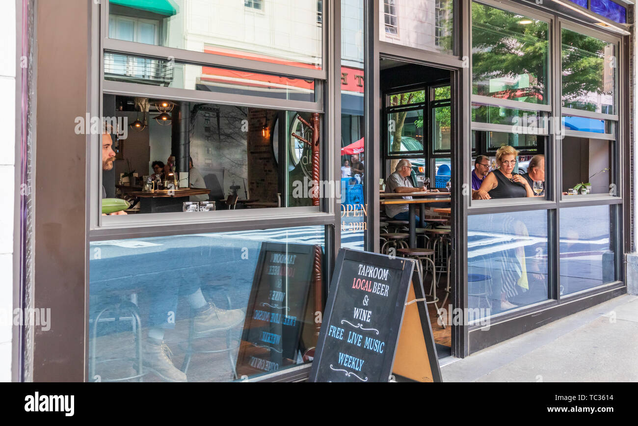 ASHEVILLE, NC, USA-5/31/19: The Taproom, a beer and wine bar in downtown Asheville, with open windows and patrons inside. Stock Photo