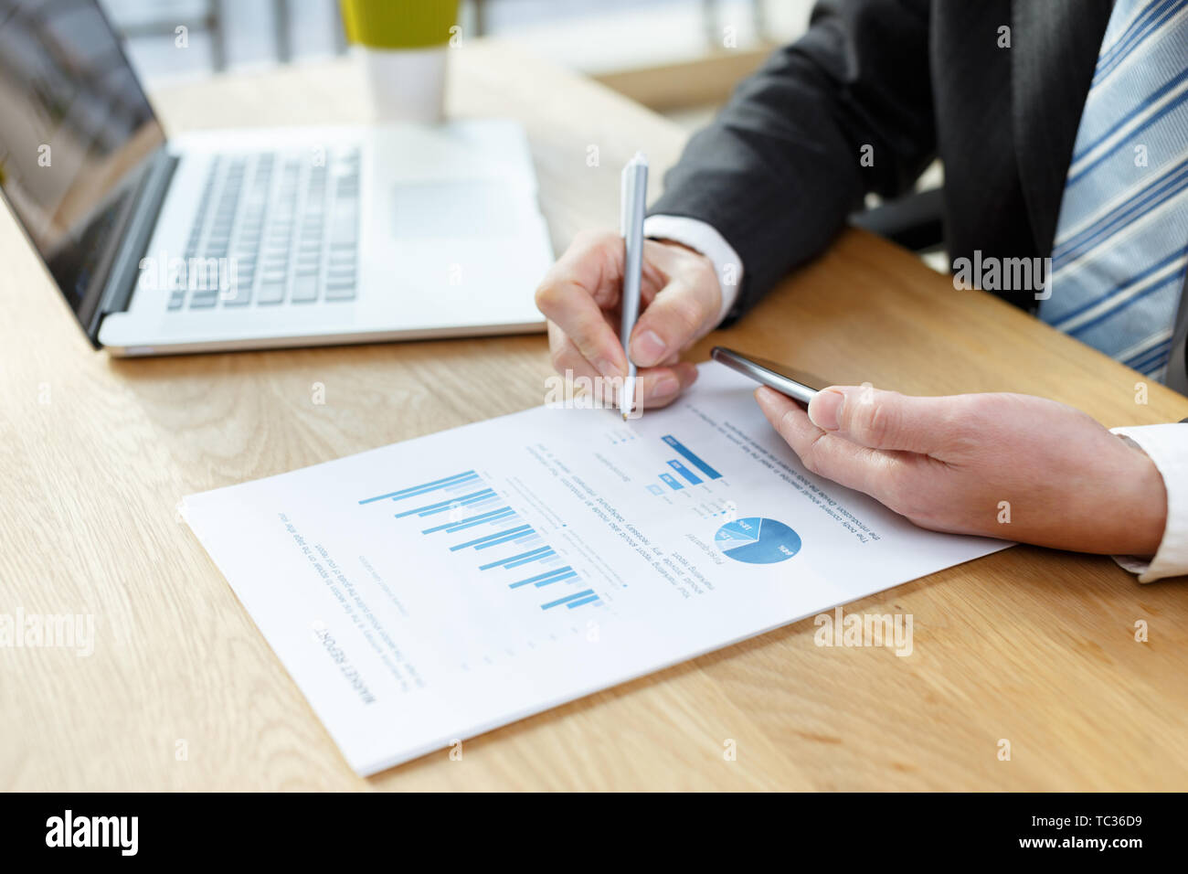 businessman checking financial reports on table Stock Photo