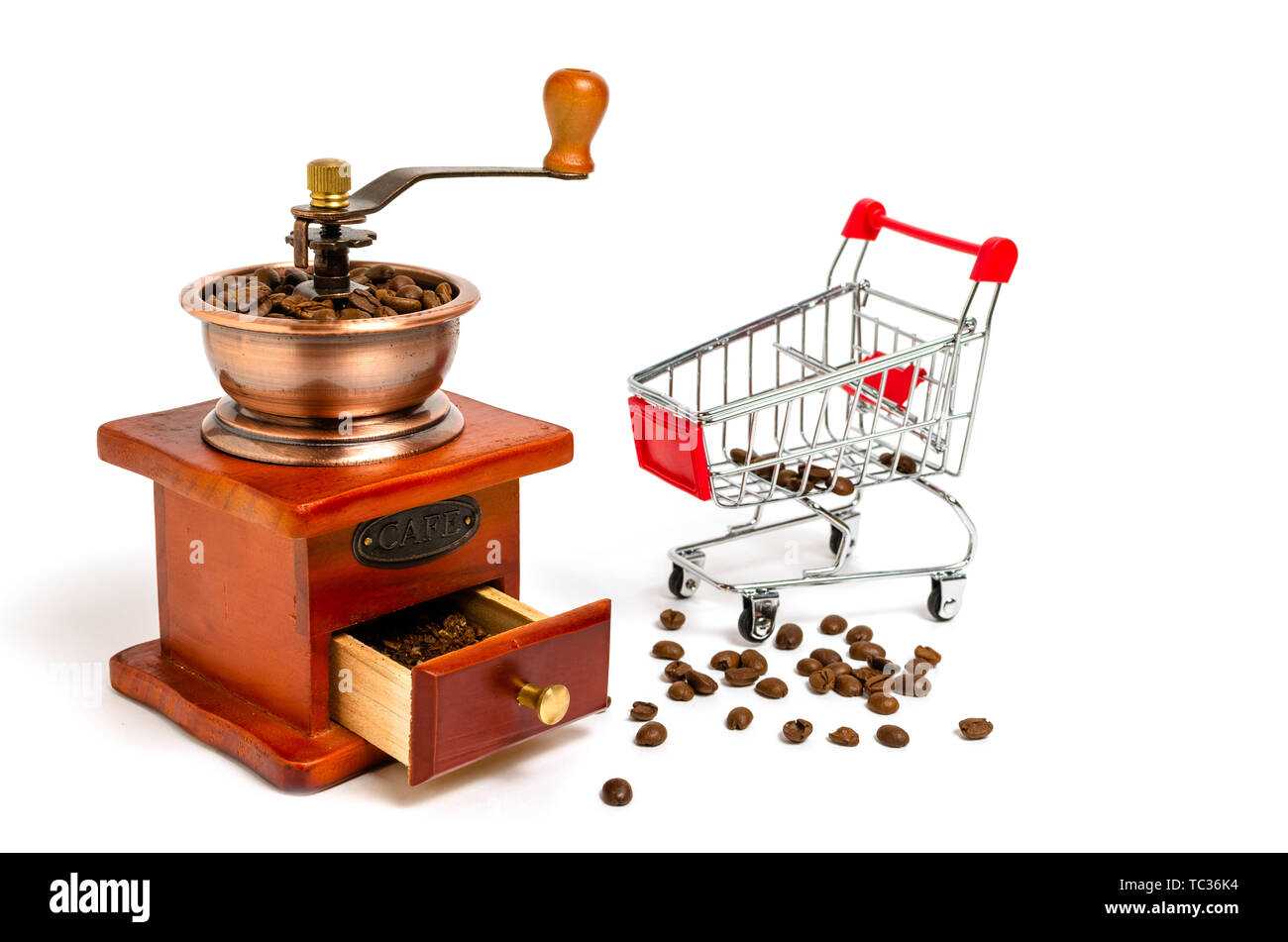 Wooden coffee grinder with coffee beans and trolley from supermarket on