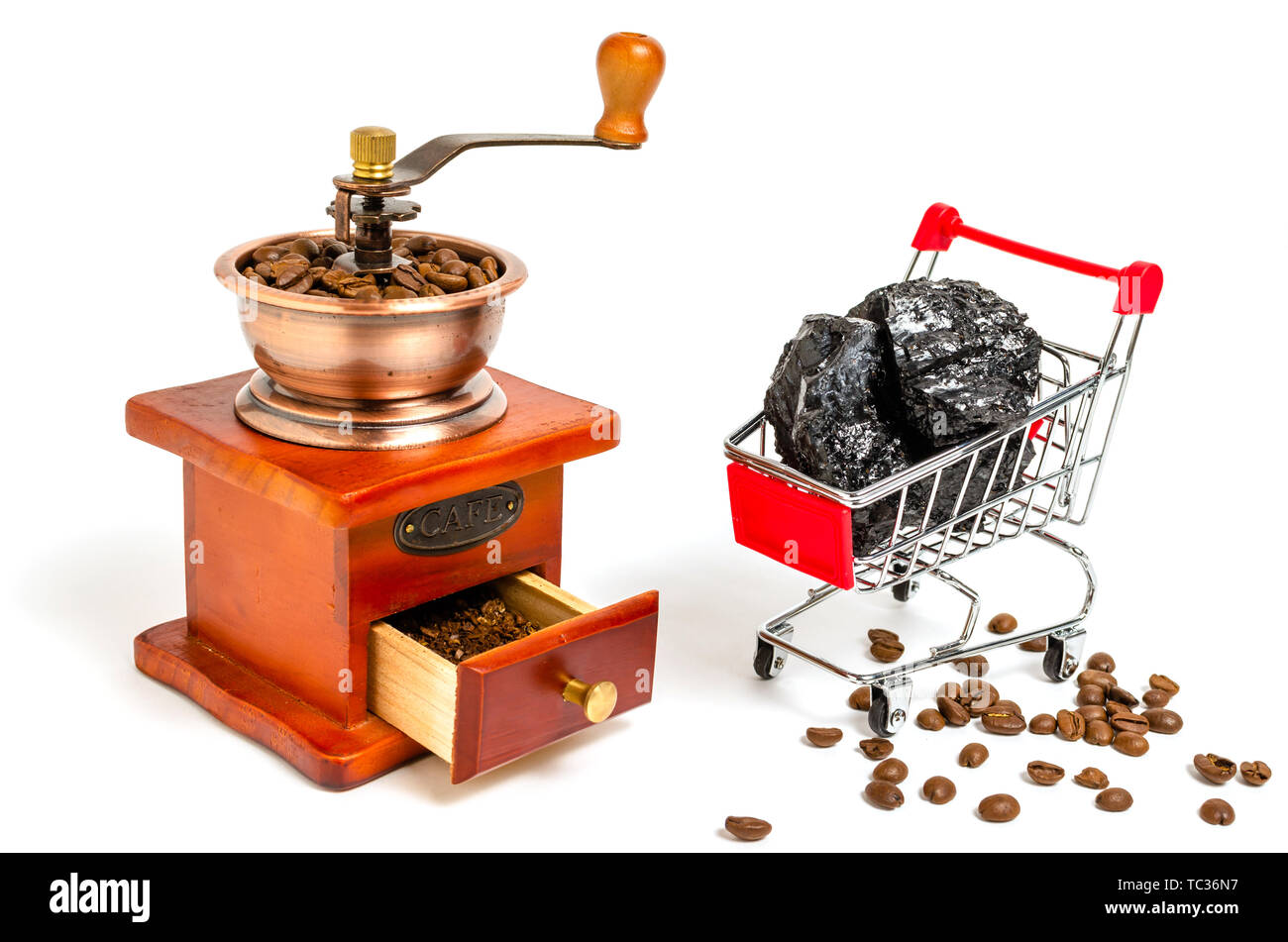 Wooden coffee grinder with coffee beans and trolley with black coal