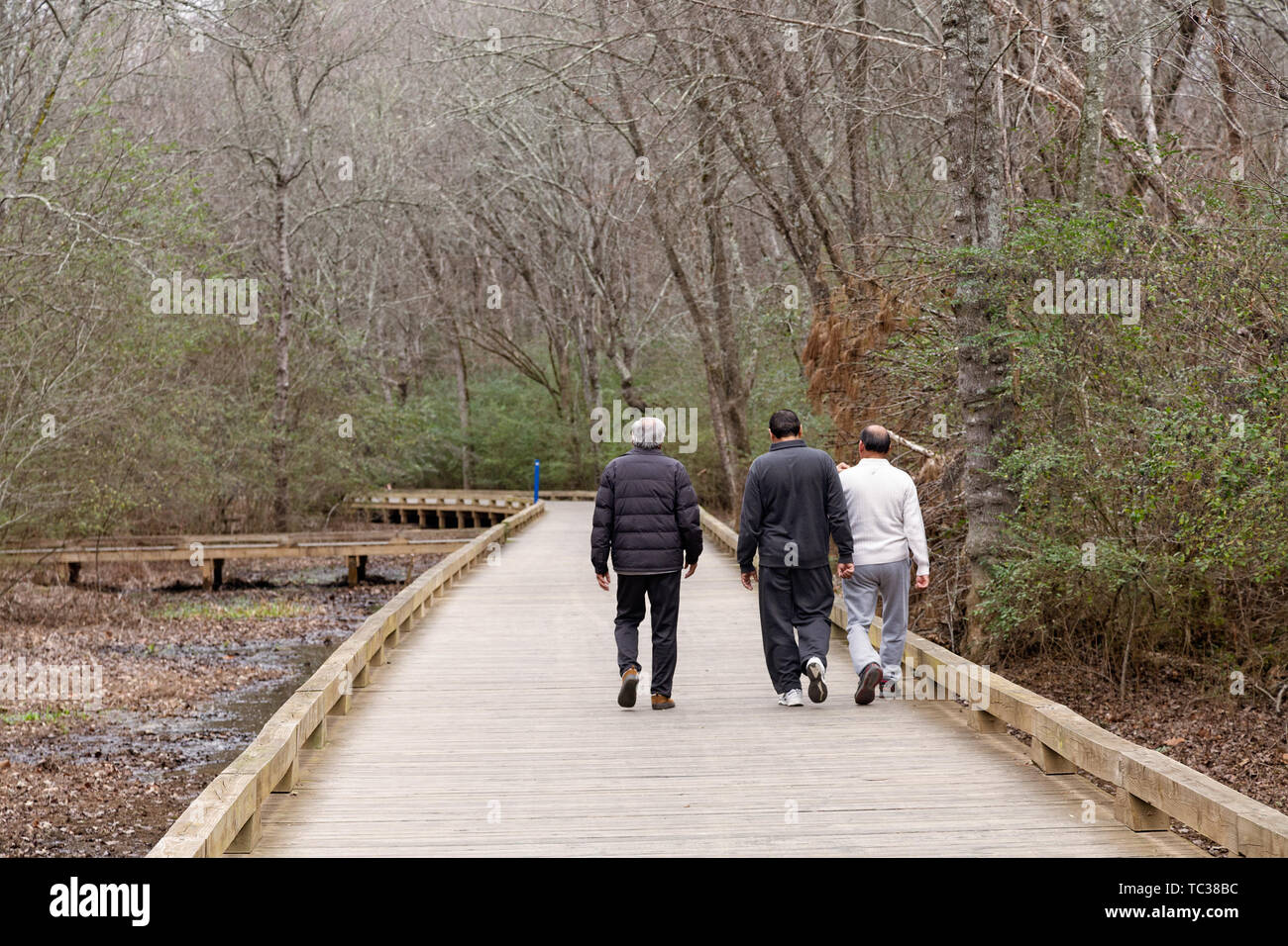 Three Men on a Walking path Stock Photo