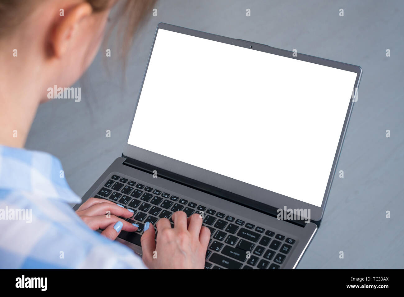 Woman freelancer typing on laptop computer keyboard with white blank ...