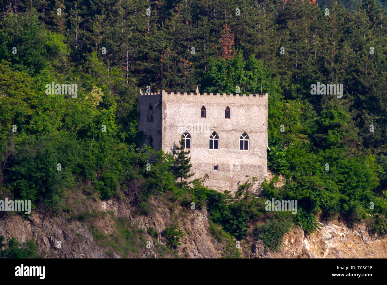 Castle on hillside cruising through the Iron Gate gorges on the Danube River between Serbia and Romania Stock Photo