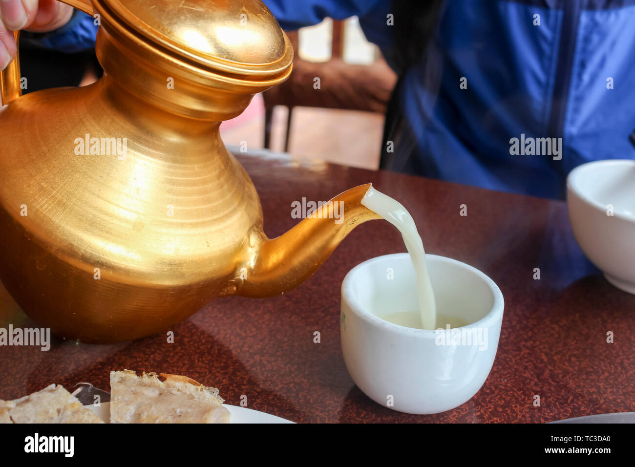 Pour ghee tea Stock Photo Alamy