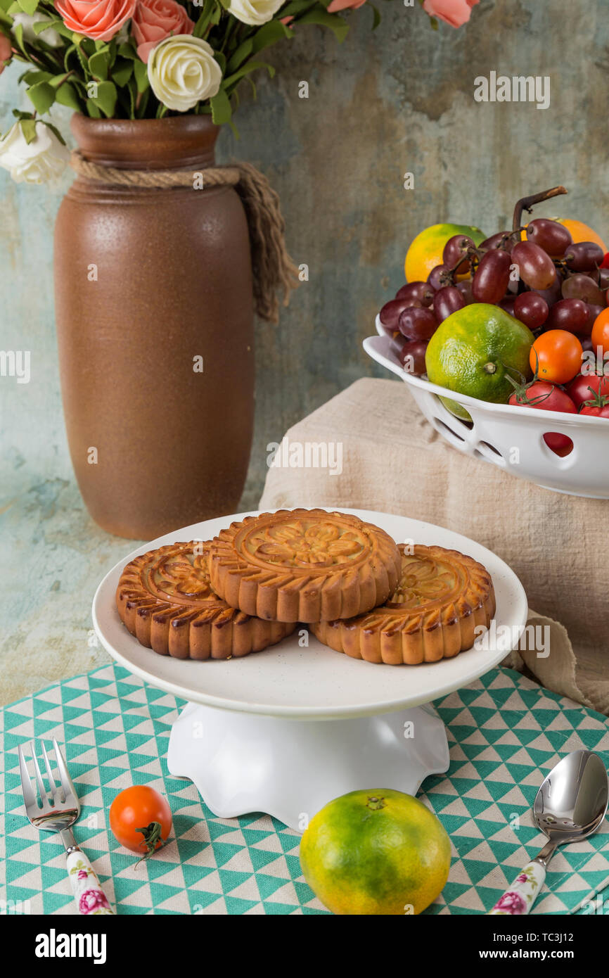 Moon cakes and fruit on the table Stock Photo