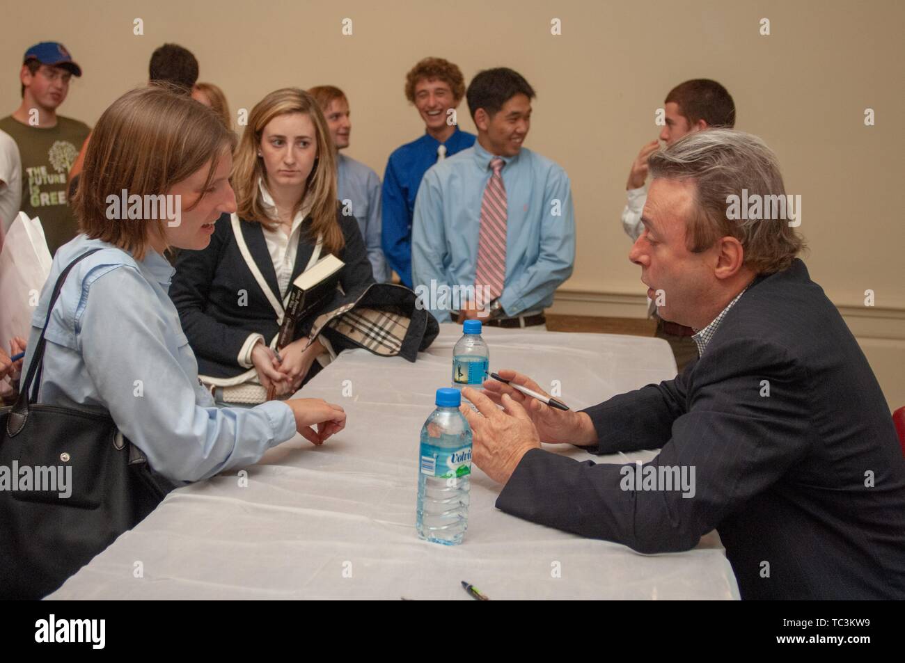 An attendee speaks with journalist Christopher Hitchens (1949 - 2011) during a Milton S Eisenhower Symposium, Homewood Campus of Johns Hopkins University, Baltimore, Maryland, September 18, 2007. From the Homewood Photography Collection. () Stock Photo