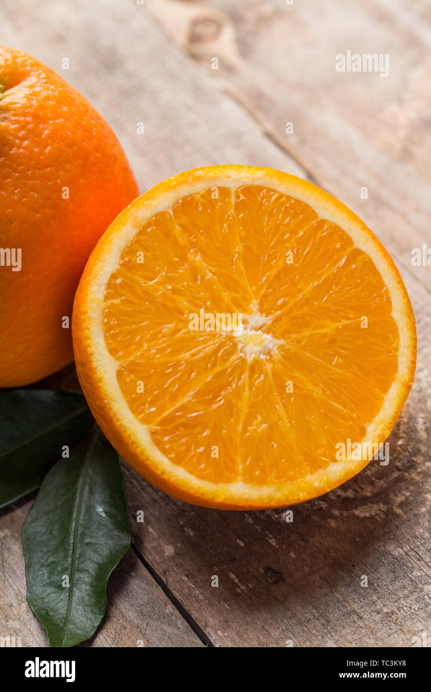 Fresh oranges on the table, one and half oranges on the table Stock Photo