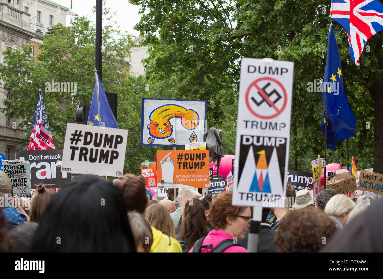 Demonstrators hold placards during the anti-Trump rally on the second day of the state visit of the American president to the UK. Stock Photo