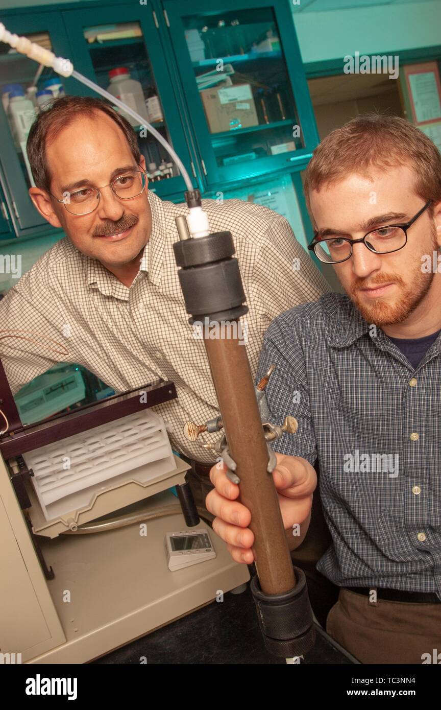Environmental Engineer Edward Bouwer and doctoral researcher Josh Weiss inspect a container of sediment at the Johns Hopkins University, Baltimore, Maryland, August 5, 2004. From the Homewood Photography Collection. () Stock Photo