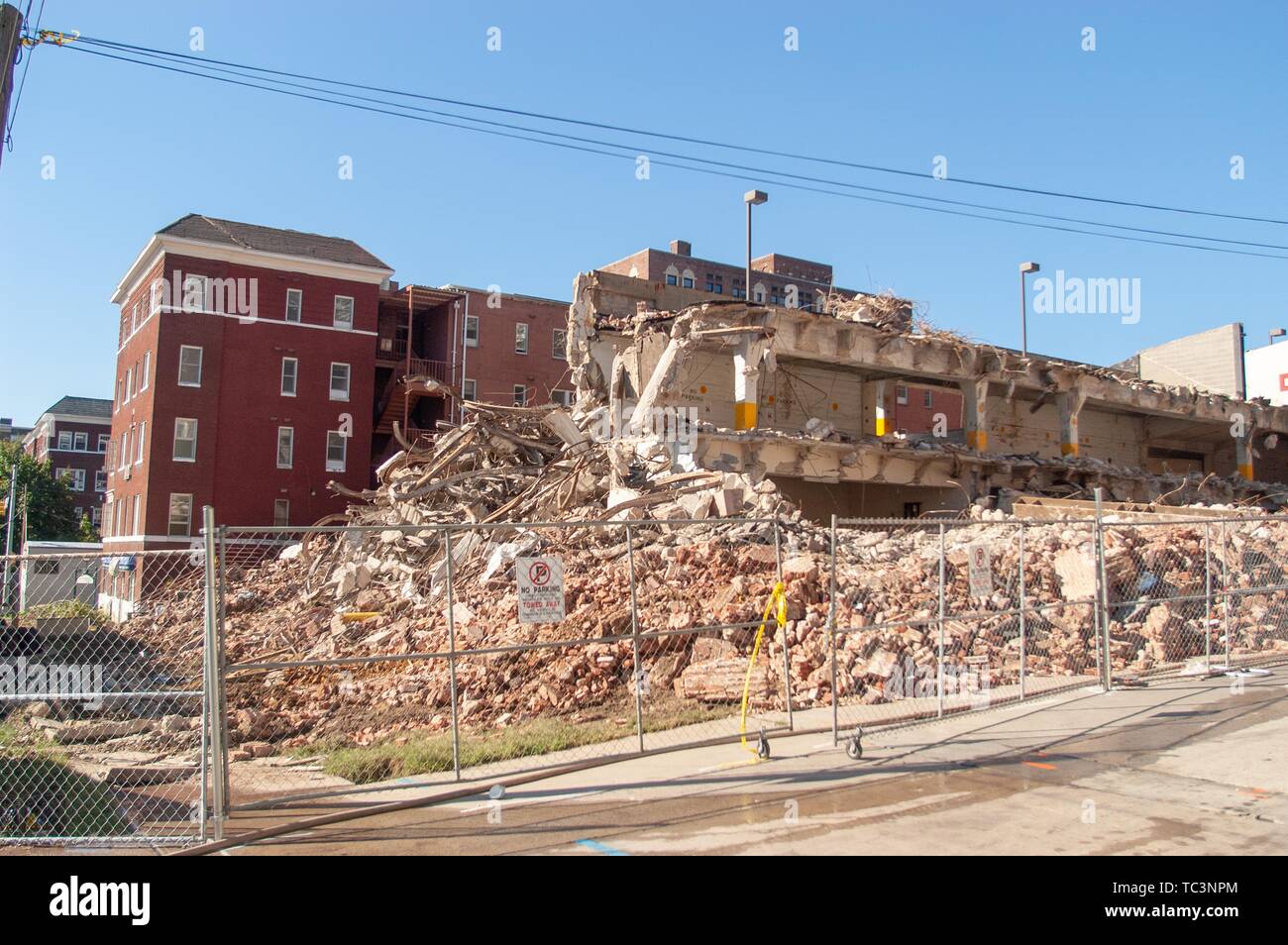 A fenced area containing demolition rubble, on a sunny day, on the Johns Hopkins University campus, Baltimore, Maryland, September 10, 2004. From the Homewood Photography Collection. () Stock Photo