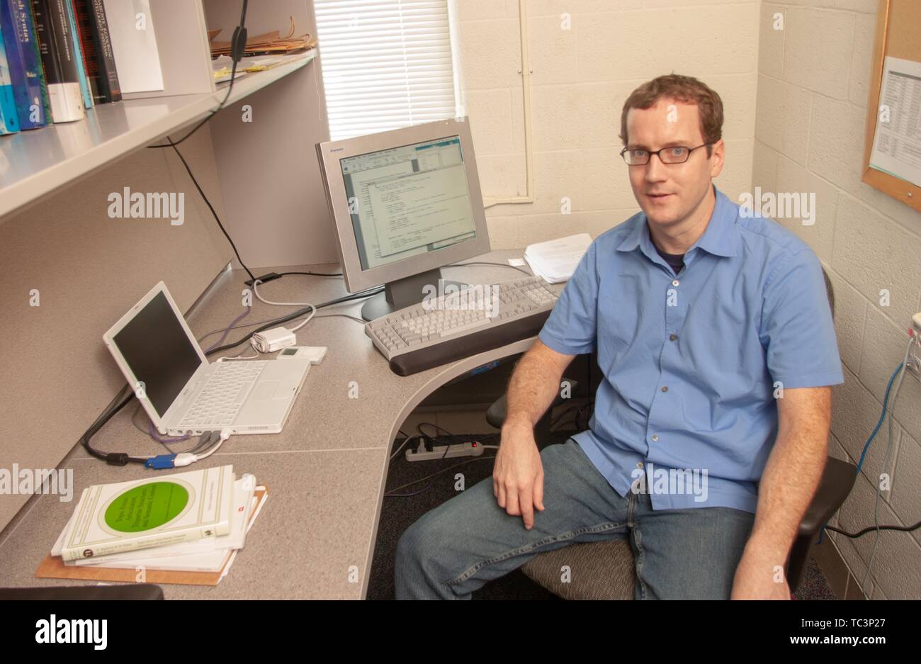 High-angle view of Center for Language and Speech Processing researcher Keith Hall, sitting in a small office at the Johns Hopkins University, Baltimore, Maryland, July 11, 2005. From the Homewood Photography Collection. () Stock Photo