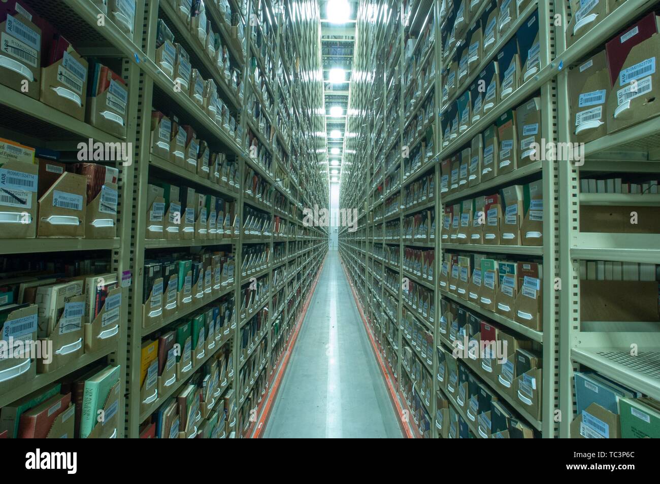 Long shot of books filed in boxes on tall shelves, in the Milton S Eisenhower Library at the Johns Hopkins University, Baltimore, Maryland, February 13, 2006. From the Homewood Photography Collection. () Stock Photo