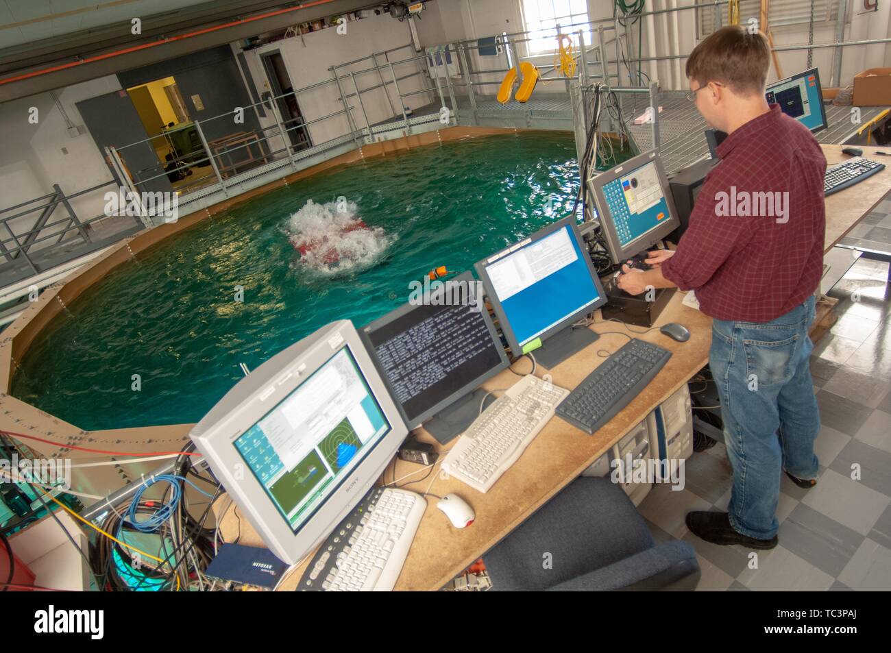 High-angle shot of a researcher, from the back, operating submarine controls in a Whiting School of Engineering lab room at the Johns Hopkins University, Baltimore, Maryland, November 3, 2006. From the Homewood Photography Collection. () Stock Photo