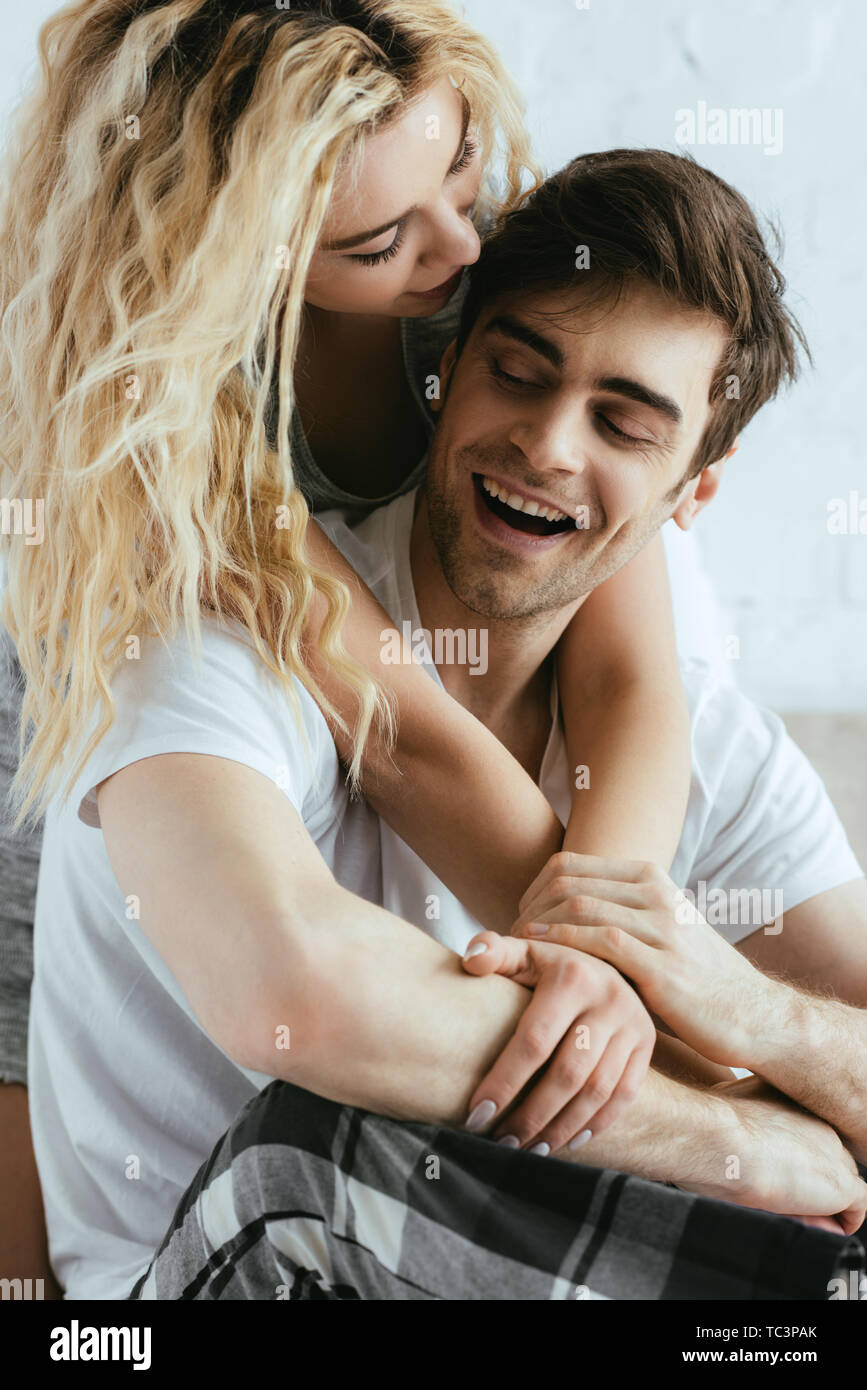 attractive blonde girl hugging happy and handsome boyfriend Stock Photo ...