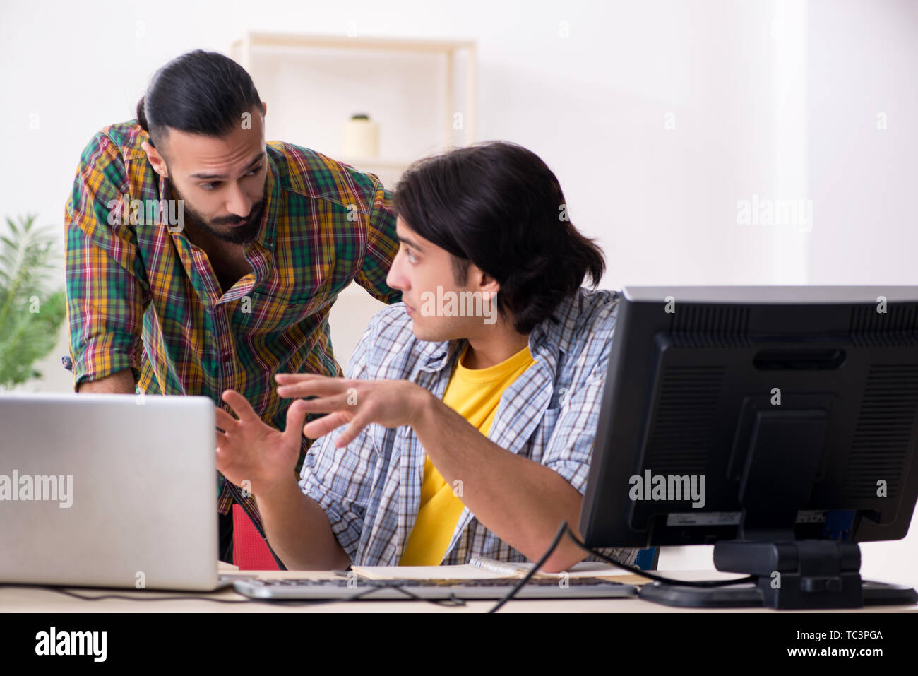Two it specialists working in the office Stock Photo