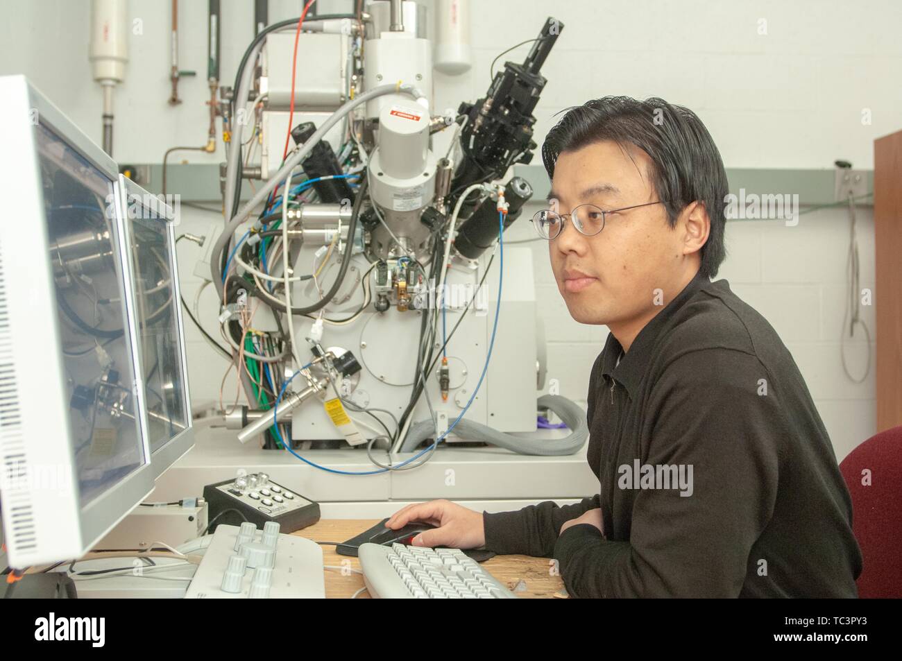 A researcher works on tandem computer screens in a Physics and Astronomy lab room at the Johns Hopkins University, Baltimore, Maryland, February 9, 2007. From the Homewood Photography Collection. () Stock Photo