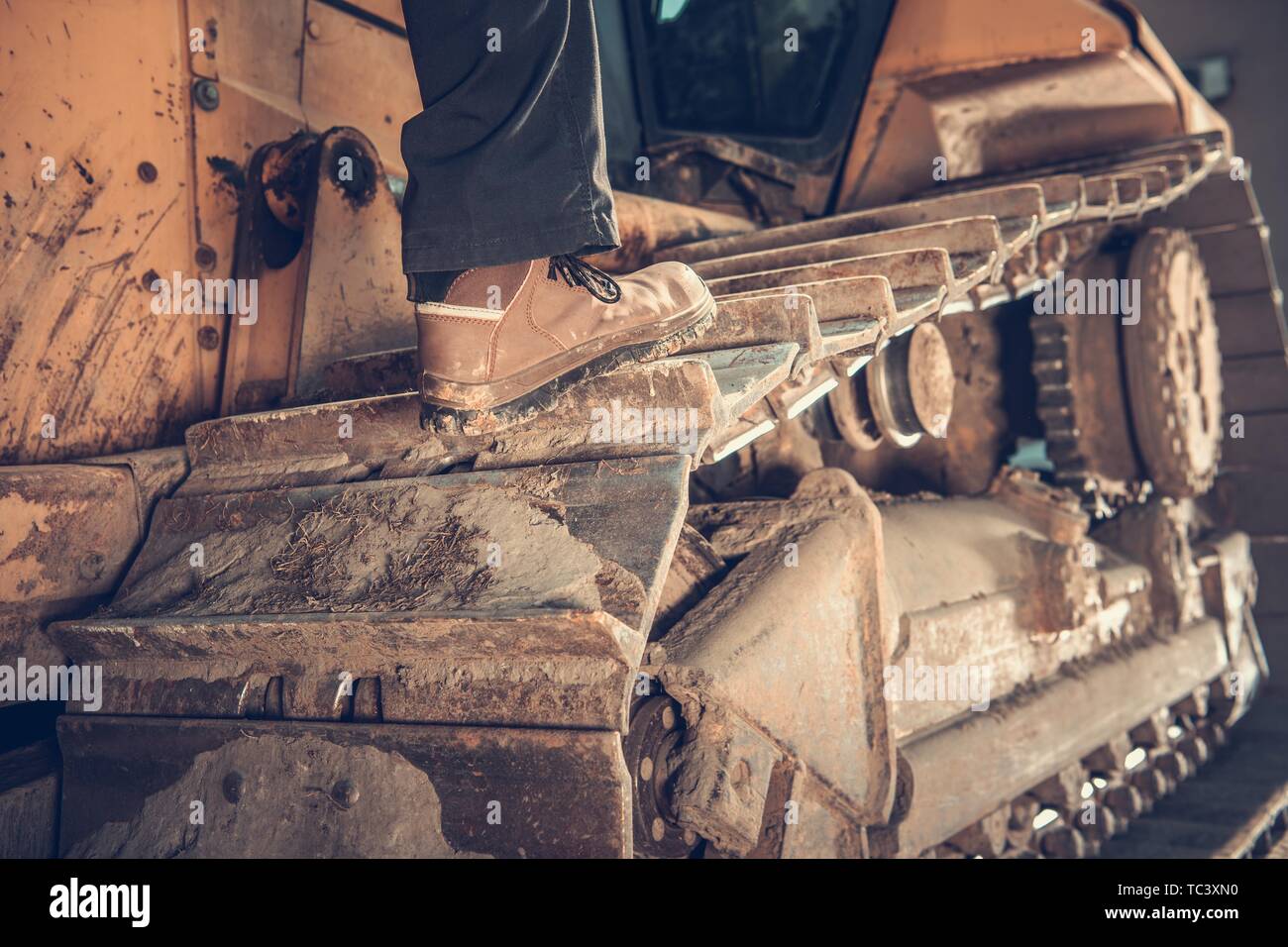 Heavy Duty Bulldozer Operator Concept Photo. Construction Equipment. Caterpillar Track Closeup. Stock Photo