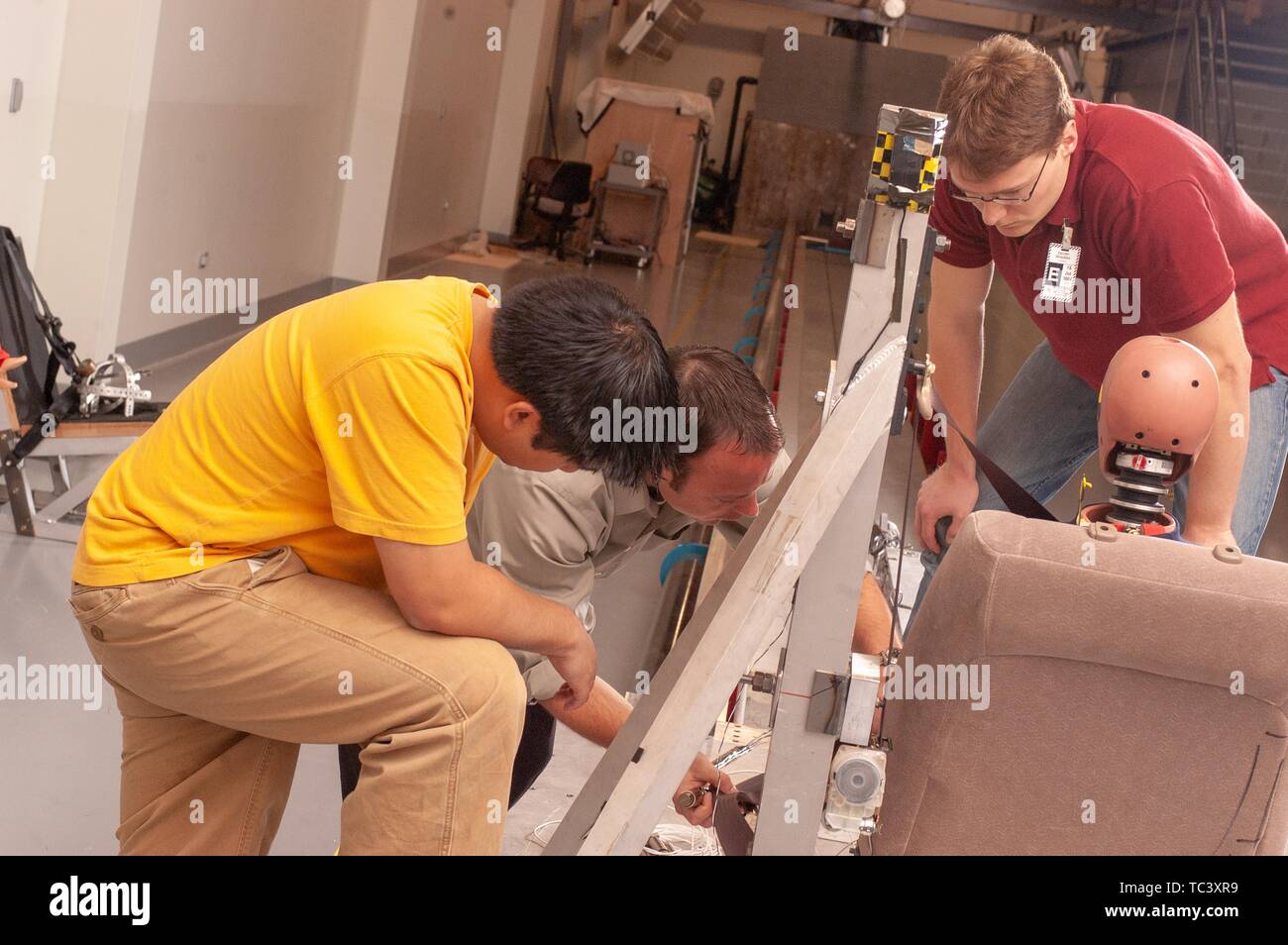 Andrew Merkle helps engineering students perfect a vehicle restraint design in the Impact Biomechanics Test Facility at the Johns Hopkins University, May 3, 2004. From the Homewood Photography Collection. () Stock Photo