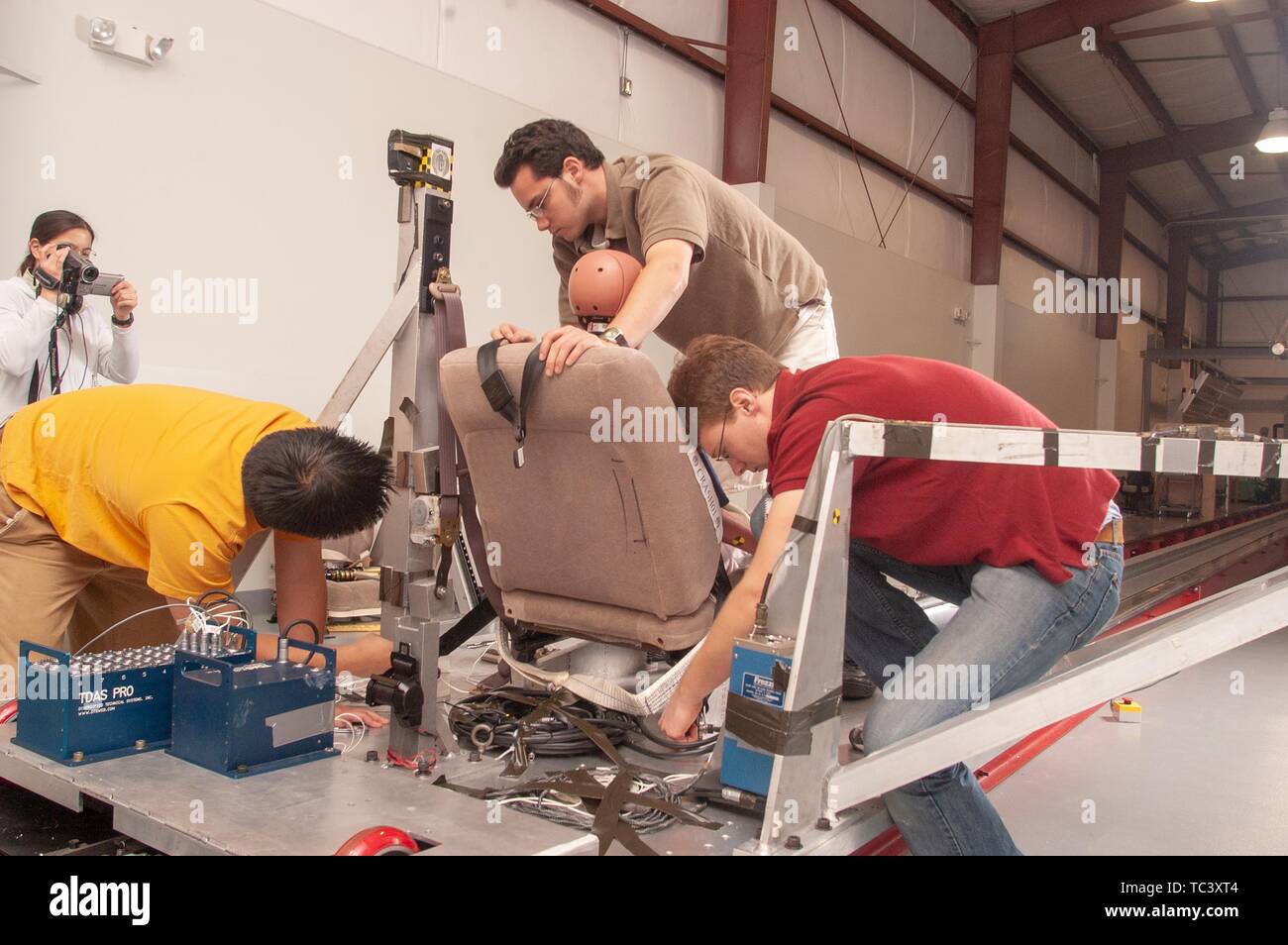 Engineering students are filmed working on vehicle restraint project in the Impact Biomechanics Test Facility at the Johns Hopkins University Applied Physics Laboratory, May 3, 2004. From the Homewood Photography Collection. () Stock Photo
