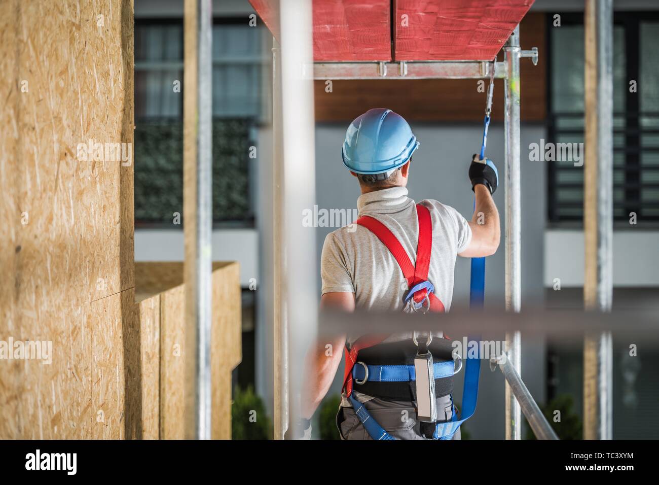 Safe Construction Work While on a Scaffolding. Safety Harness Equipment Concept. Industrial