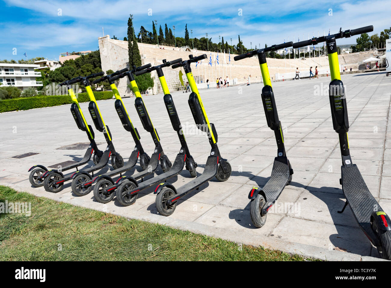 few electric scooters parked outside the panathenaic stadium in Greece