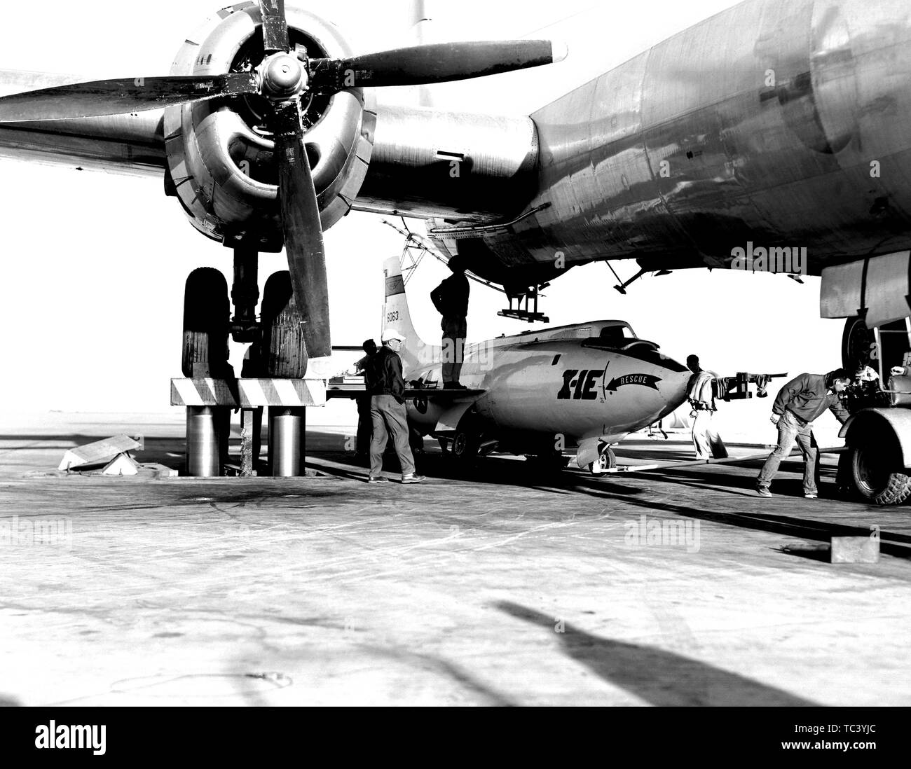 NASA engineers load a Bell Aircraft Corporation X-1E airplane under the Boeing B-29 mothership, 1955. Image courtesy National Aeronautics and Space Administration (NASA). () Stock Photo