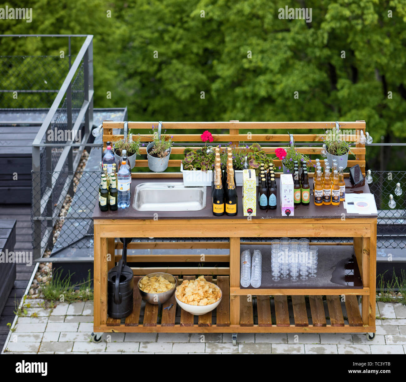 Portable table with drinks and chips prepared for a company rooftop party Stock Photo