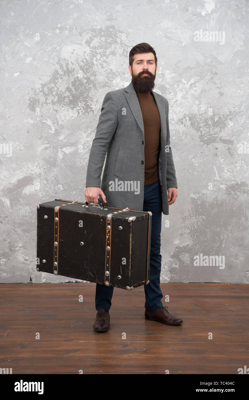 Retro and vintage. Fashion trend. Accessories for vacation. Best travel bags for men. Guy well groomed elegant bearded man and vintage suitcase. Time traveller concept. Vintage inspired design of bag. Stock Photo