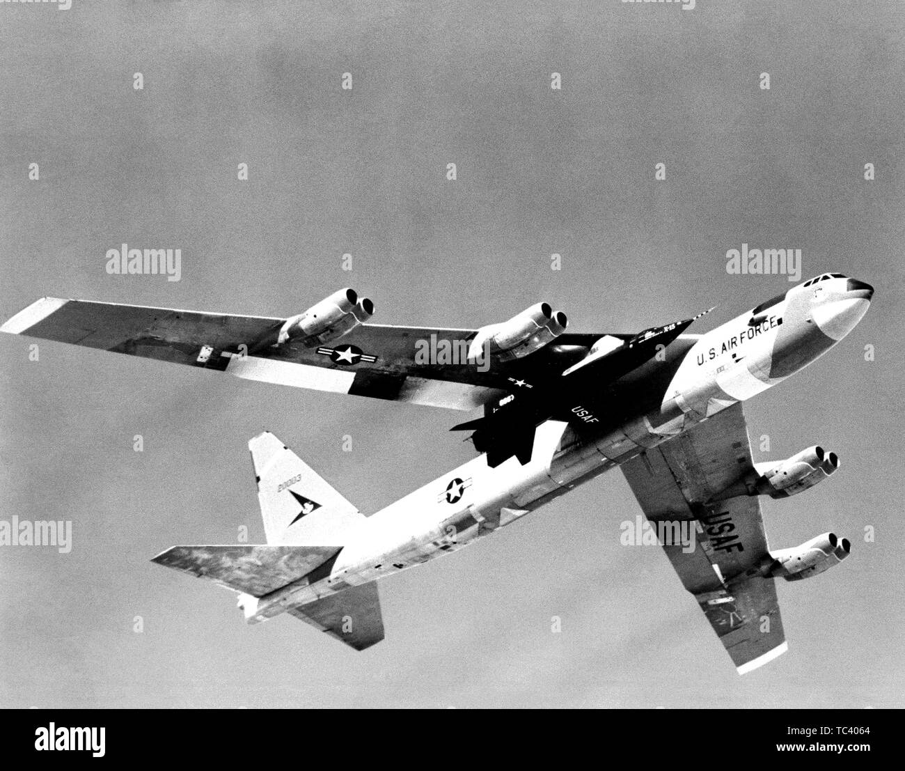X-15 rocket-powered research aircraft is carried aloft under the wing of its B-52 mothership, 1959. Image courtesy National Aeronautics and Space Administration (NASA). () Stock Photo