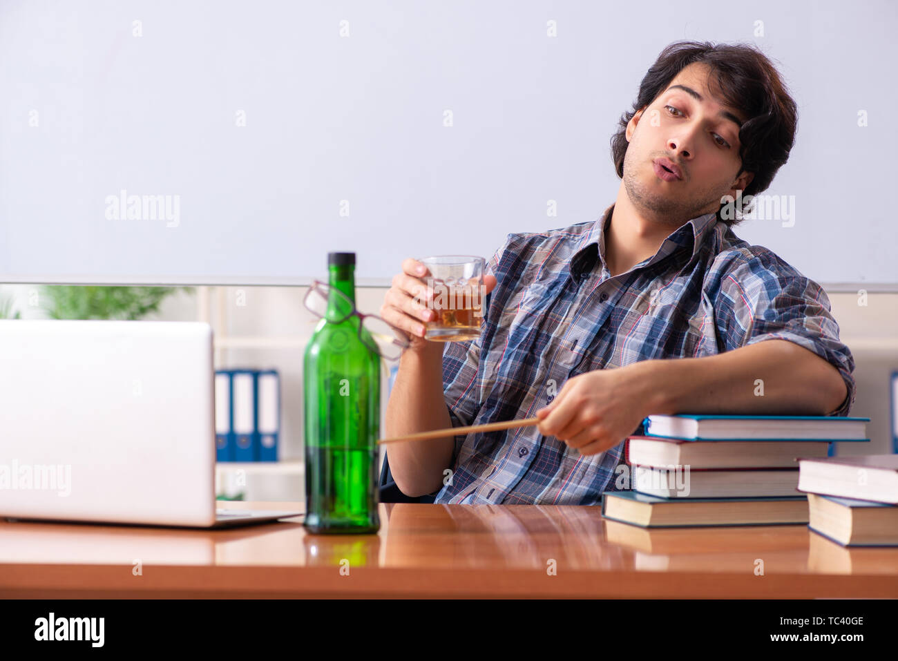 Male teacher drinking in the classroom Stock Photo Alamy