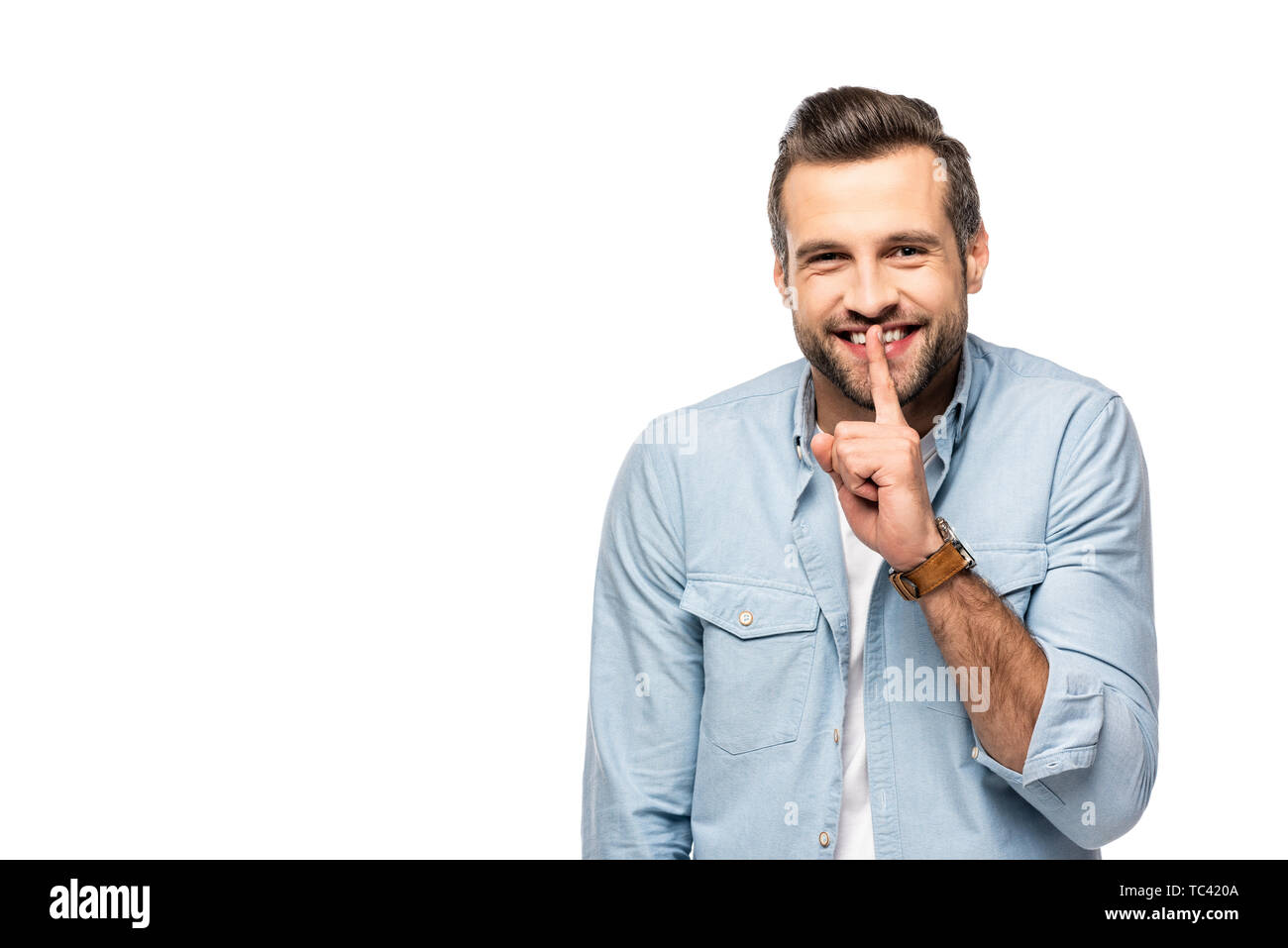 happy man with finger on mouth Isolated On White with copy space Stock Photo