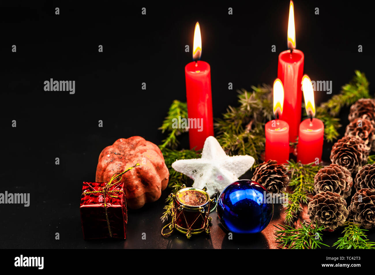 Christmas candles on black background Stock Photo - Alamy