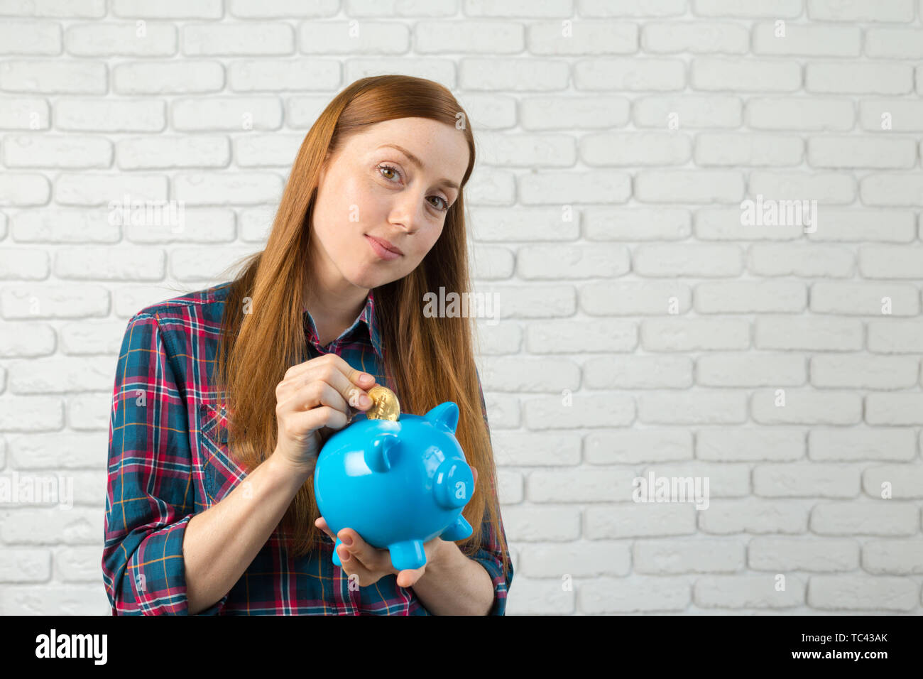 Young woman with piggy bank Stock Photo - Alamy