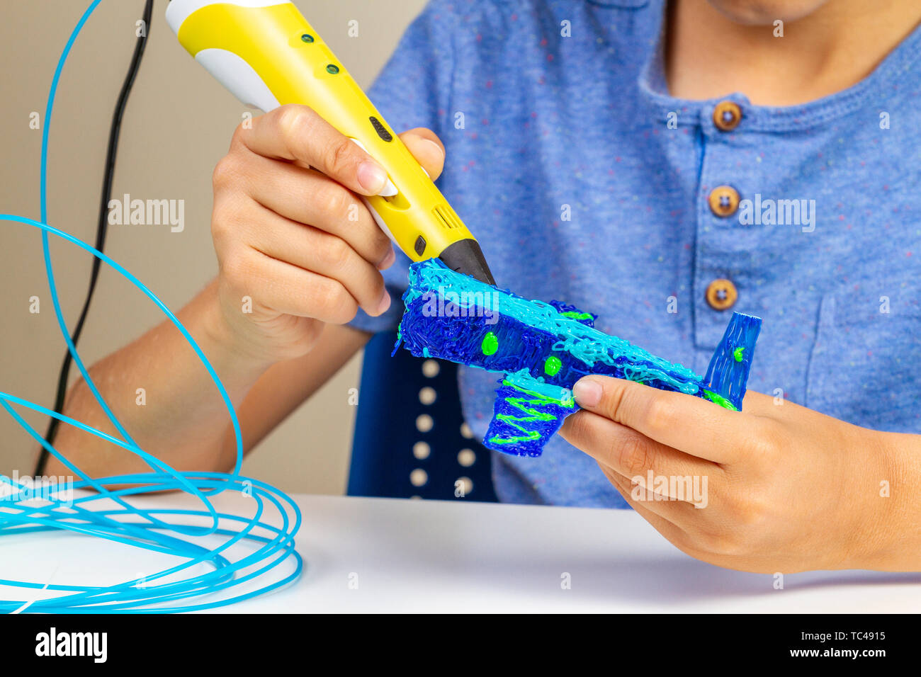 Boy hands creating with 3d printing pen new object Stock Photo - Alamy