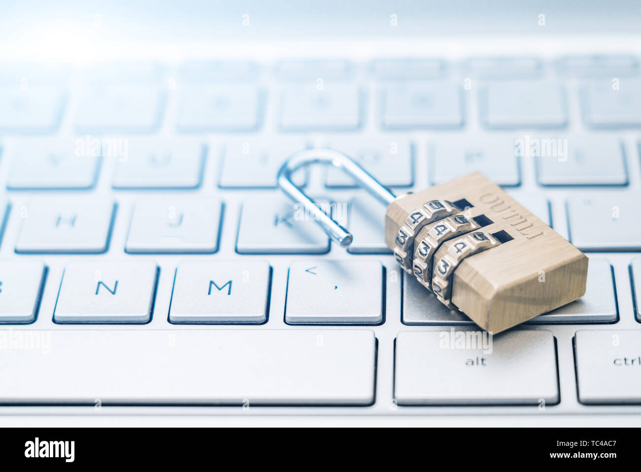 An open lock on a computer keyboard. Stock Photo