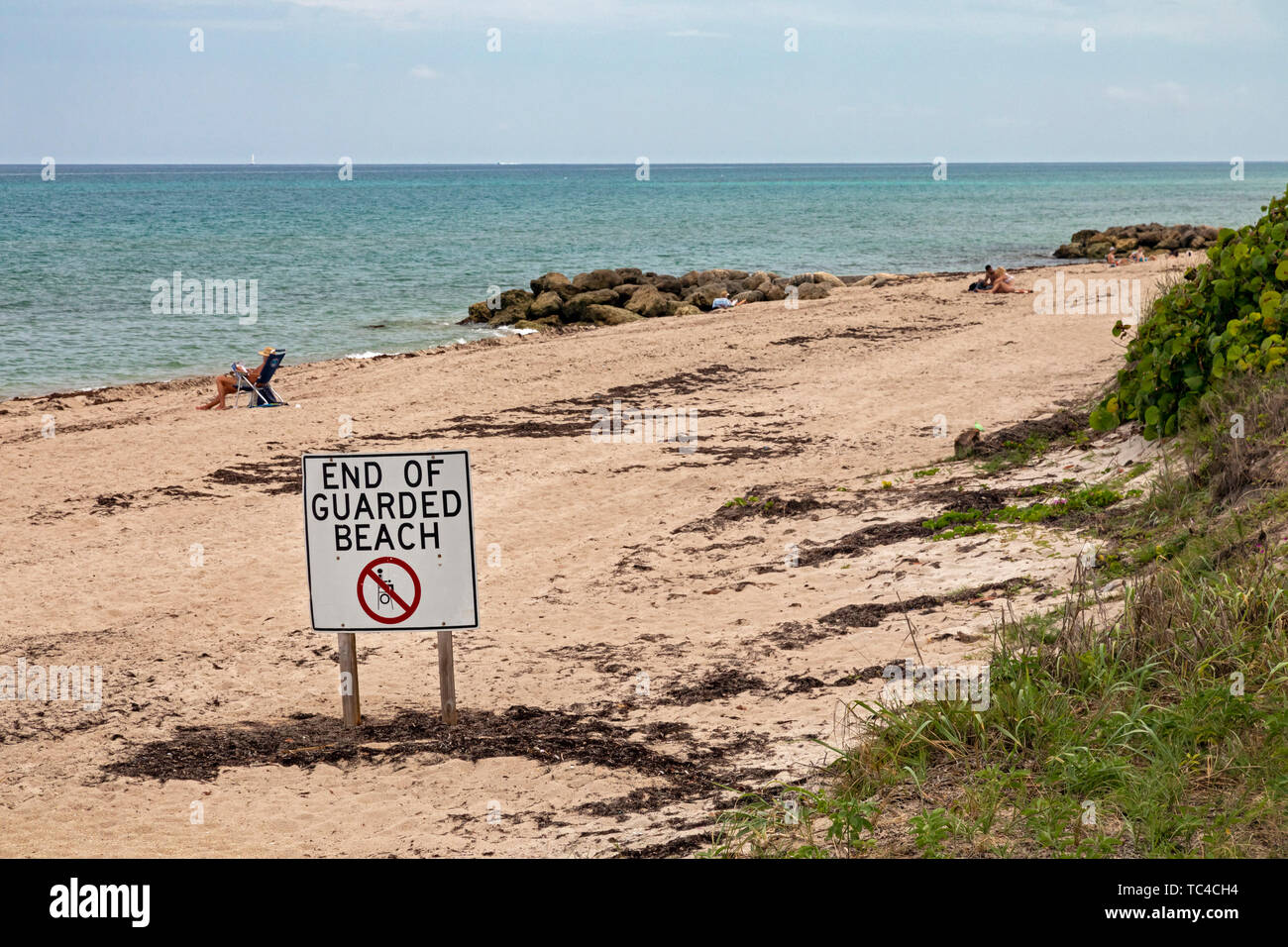 West Palm Beach, Florida - A sign warns that no lifeguards are provided beyond a sign on the beach along the Atlantic Ocean. Stock Photo