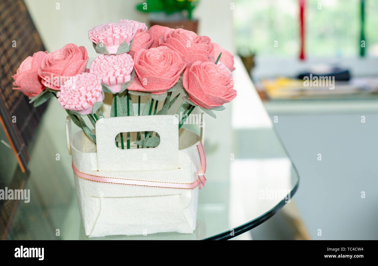 A flower arrangement on a glass table. Stock Photo