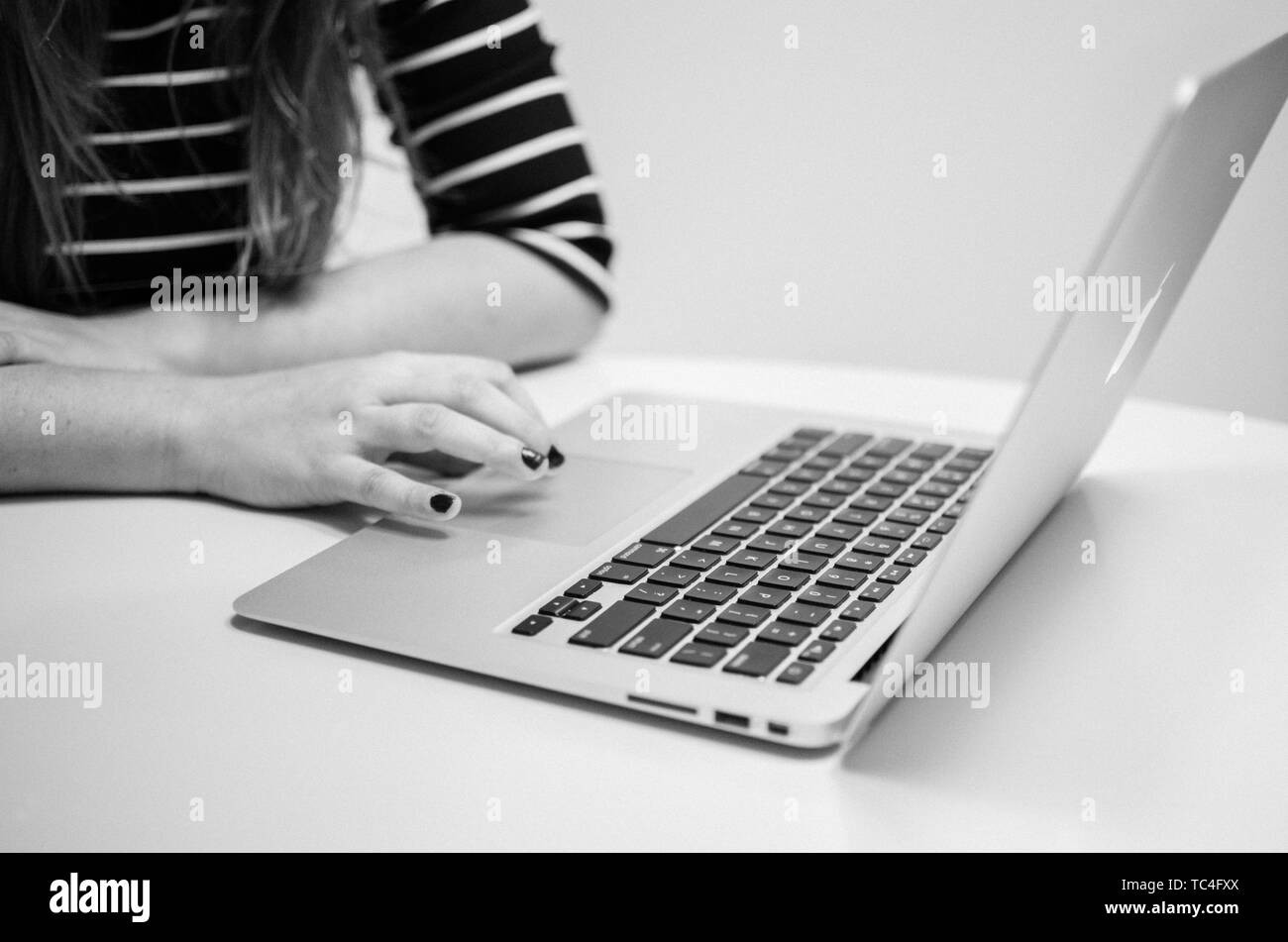 CIUDAD AUTONOMA DE BUENOS AIRES, ARGENTINA - Aug 09, 2016: Close up to a woman's hand while working with a computer. Stock Photo