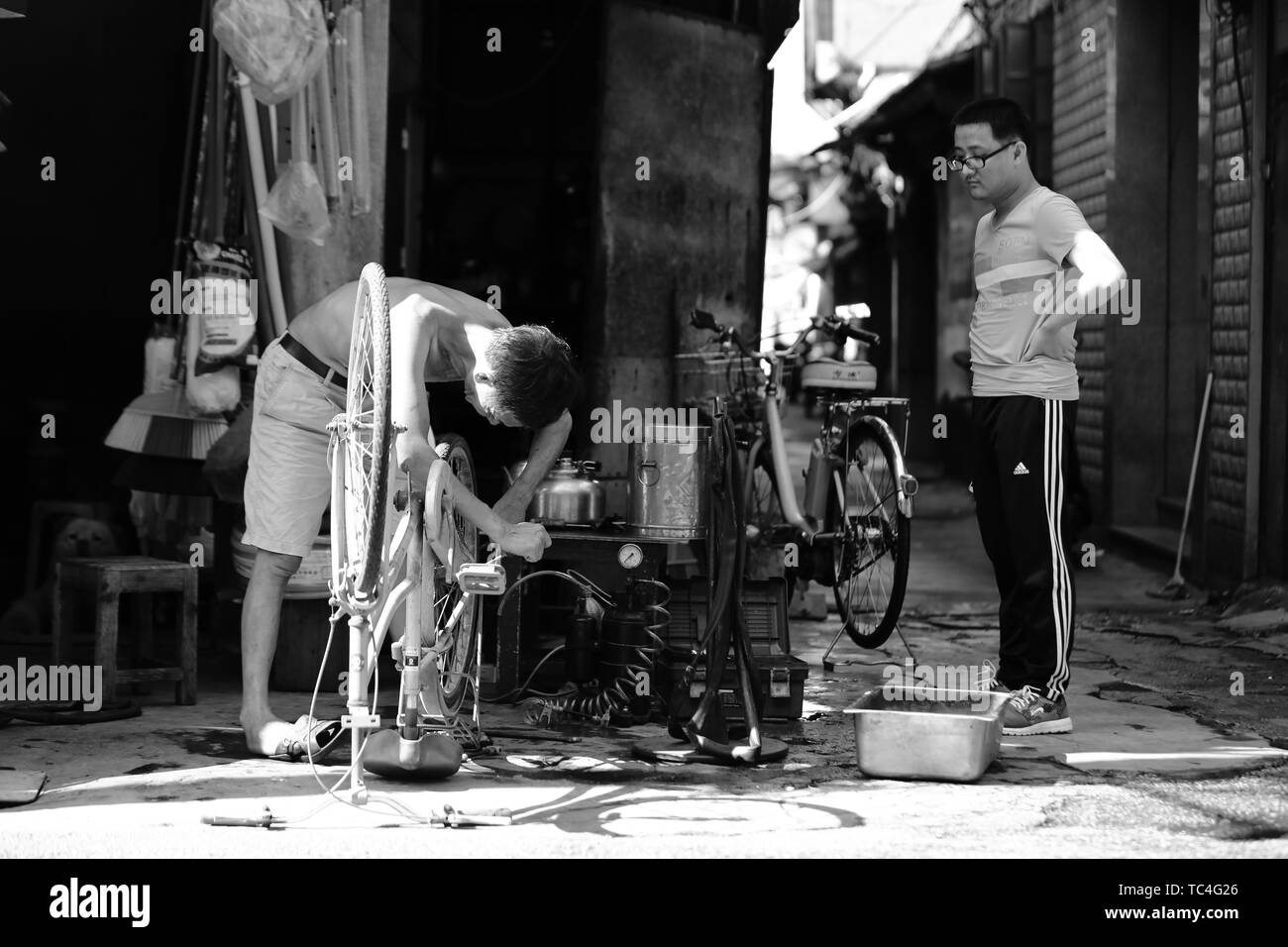 Old man repairing bicycles Stock Photo